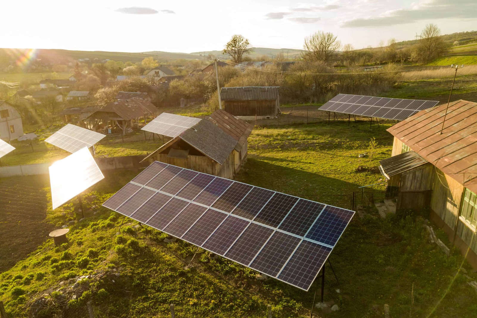 A rural village with solar panels installed on rooftops providing electricity to the community